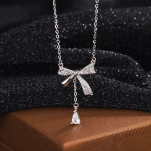 Sterling silver bow tassel necklace, elegant and sophisticated clavicle chain with teardrop pendant.